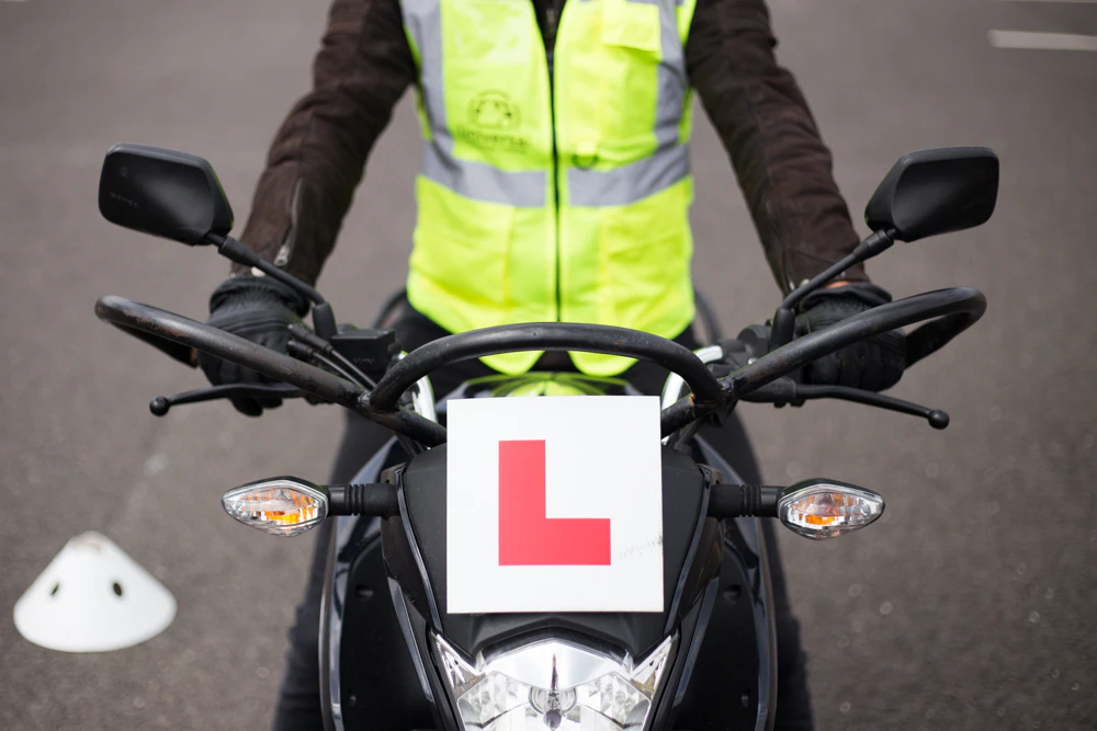 Trainee with high-vis learning to ride 
