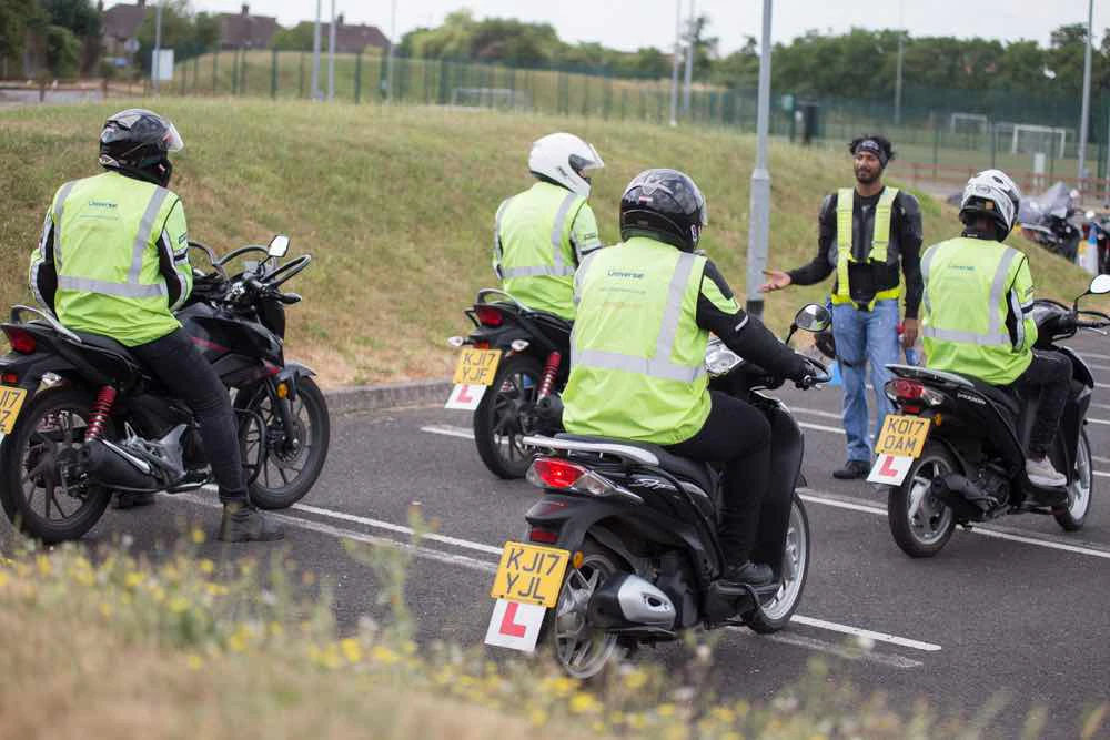 Instructor working with four riders